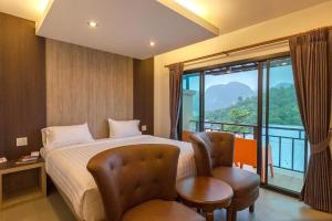 Habitación de hotel con cama y balcón en Phi Phi Top View Resort en Islas Phi Phi