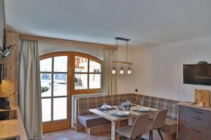 a living room with a table and a couch at Ferien Bauernhof Maurachhof in Sankt Johann im Pongau