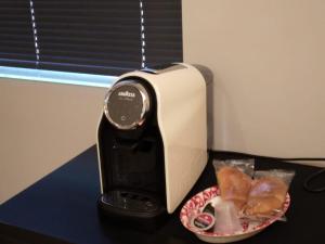 a toaster sitting on a table with a plate of food at Oasi dei Geni in Foggia