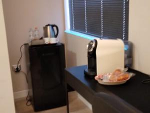 a counter with a coffee maker and a plate of food at Oasi dei Geni in Foggia +17 photos
