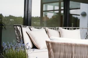 un grupo de almohadas blancas sentadas en un sofá en Barsebäck Resort Hus, en Löddeköpinge