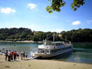 a group of people waiting to board a boat on a river at Ferienhaus LENA im Sauerland direkt am Hennesee in Meschede
