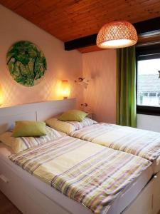 a bedroom with two beds and a window at Ferienhaus LENA im Sauerland direkt am Hennesee in Meschede