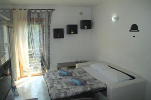 a bedroom with a bed in a room with a window at Casa Vela in Riva del Garda