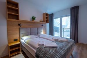 Posteľ alebo postele v izbe v ubytovaní Apartamenty na Uroczysku