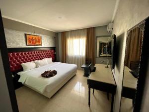 a bedroom with a large bed and a desk and a bed sidx sidx at Washington Hotel in Casablanca