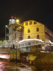 a large building with a lighthouse at night at Elegante apartamento centrale in Tríkala