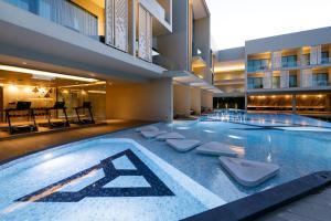 a swimming pool in the middle of a building at The Signature Hotel Airport in Hat Yai