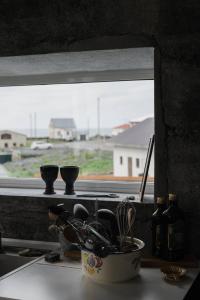 a bowl of kitchen utensils sitting on a window sill at Melar Guesthouse in Kópasker