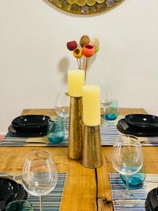a wooden table with wine glasses and candles on it at Hotel Apartment with 2-en suite Bedrooms in Palma de Mallorca