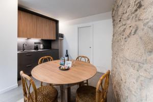 a kitchen with a wooden table and chairs at GuestReady - Casa da Alegria 8 in Porto