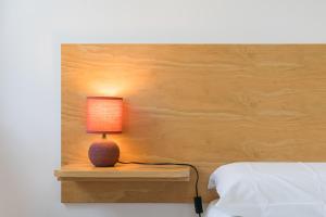 a lamp sitting on a night stand next to a bed at Contemporary countryside haven in Mangualde in Mangualde