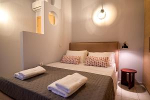 a bedroom with a bed with two pillows on it at Villa Cool with Private Pool, Mountain & Sea View in Ayía Marína +46 photos