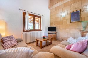 a living room with two couches and a tv at Can Jaume in Pollença