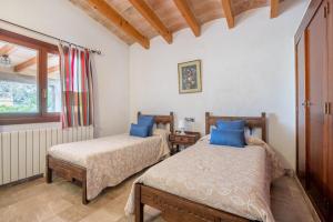 a bedroom with two beds and a window at Can Jaume in Pollença +21 photos