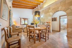 a kitchen and living room with a table and chairs at Can Jaume in Pollença