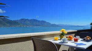 a table with food and a view of the ocean at Hotel Gajeta in Gaeta