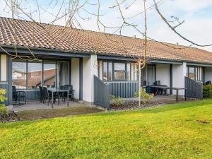 une maison avec une terrasse et une pelouse dans l'établissement Holiday home Gjern IV, à Gjern