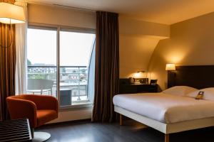 Ένα ή περισσότερα κρεβάτια σε δωμάτιο στο Escale Oceania Pornichet La Baule +39 φωτογραφίες