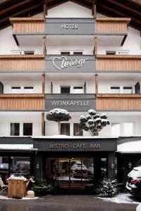 un hotel con un cartel para un bar cafetería bistró en Hotel Universo, en Serfaus