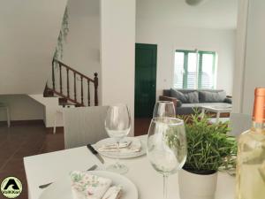 stół jadalny z dwoma kieliszkami wina w obiekcie VolKKanrentals SunBeam House w mieście Famara