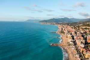 an aerial view of a beach and the ocean at Ligure Residence in Pietra Ligure