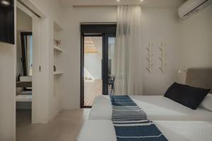 a bedroom with a bed and a view of a bathroom at Villa Dimi private pool, sea view & 3 bedrooms in Paleros +48 photos