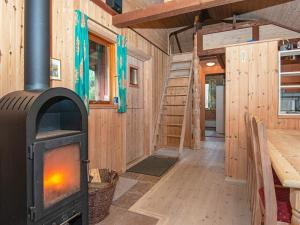 a wood stove in the middle of a room at Holiday home Hovborg IX in Hovborg