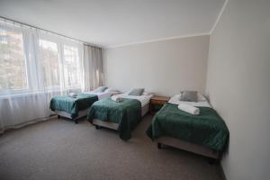 Łóżko lub łóżka w pokoju w obiekcie Hotel Felix