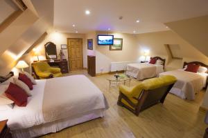 a hotel room with two beds and a television at The Tides Ballybunion in Ballybunion