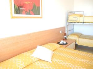 a bedroom with two beds and a picture on the wall at Renovated flat next to the beach - Beahost in Bibione