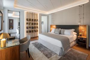 a bedroom with a bed and a desk with a chair at Casa Baglioni Milan - The Leading Hotels of the World in Milan +79 photos