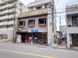 a building on the side of a city street at Stay Inn KOTO in Kyoto