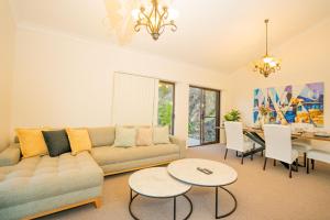 a living room with a couch and a table at Bushland Retreat in Gold Coast