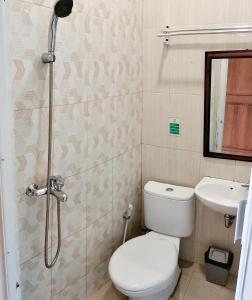 a bathroom with a shower and a toilet and a sink at The Cabin Purwokinanti Hotel in Yogyakarta +21 photos