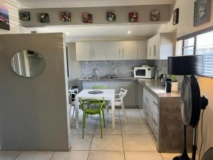 a kitchen with a table and chairs in it at 28 on Symonds Luxstudio 2 in George