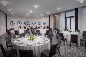 a conference room with white tables and chairs at Andaz Savannah, By Hyatt in Savannah +32 photos