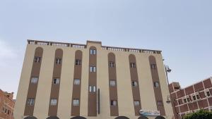 a tall building with many windows on it at Residence el khanchi in Laayoune