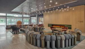 a salon with a row of chairs and a fireplace at Hyatt Regency Zurich Airport Circle in Kloten