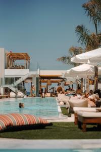 a swimming pool with chairs and people in a resort at Galazio Beach Resort by Estia in Hersonissos