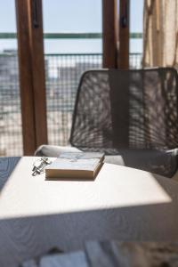 a book on a table with a pair of glasses at Titan, edificio Hipercor, con Parking in Huelva