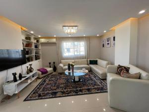 a living room with a couch and a table at Unique apartment in Almaza in Cairo