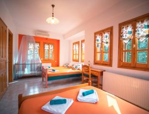 A bed or beds in a room at Orange House for big families in Damouchari - Delicious Houses