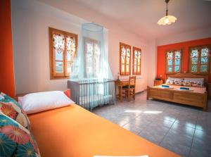 A bed or beds in a room at Orange House for big families in Damouchari - Delicious Houses