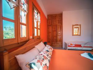 A bed or beds in a room at Orange House for big families in Damouchari - Delicious Houses