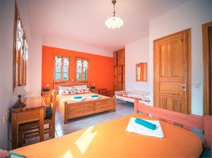 A bed or beds in a room at Orange House for big families in Damouchari - Delicious Houses