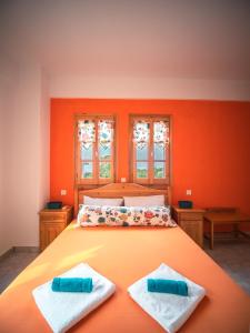 A bed or beds in a room at Orange House for big families in Damouchari - Delicious Houses