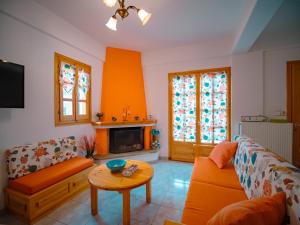 A seating area at Orange House for big families in Damouchari - Delicious Houses