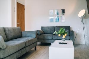 een woonkamer met 2 banken en een salontafel bij Freda House By Horizon Stays in Sunderland