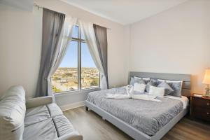 a bedroom with a bed and a large window at Emerald 705 in Galveston +26 photos